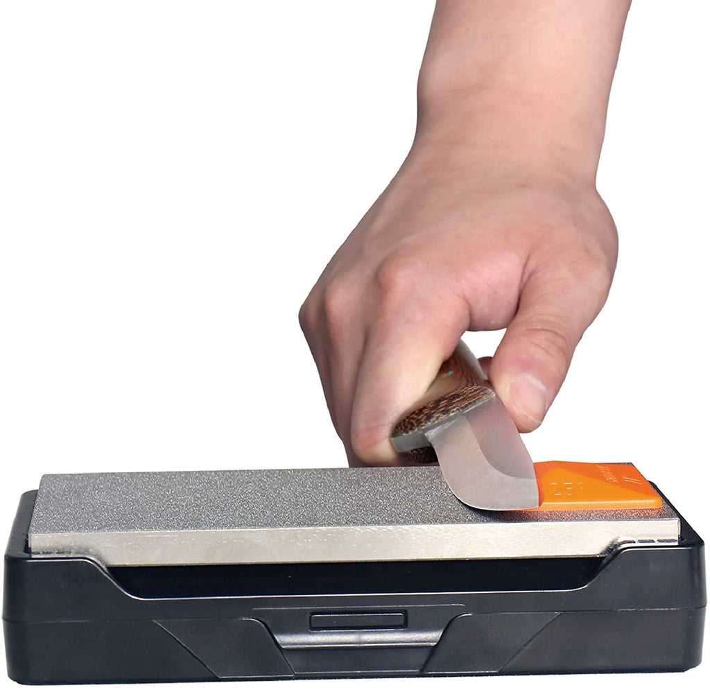 Hand using a knife sharpener with a white background