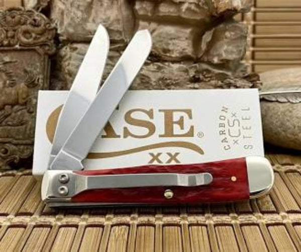 Red and silver pocket knife with 'Case' branding on a wooden surface.